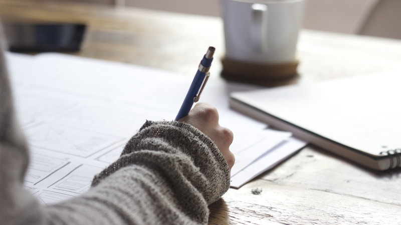 Person studying and writing notes at a desk